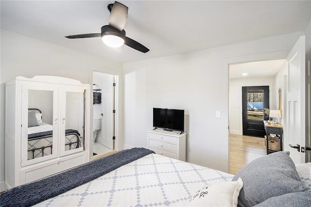 bedroom with a ceiling fan, baseboards, and wood finished floors