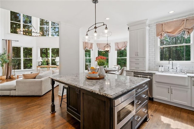 6219 Creekstone Path, Cumming, GA 30041 - kitchen with a chandelier, a sink, appliances with stainless steel finishes, healthy amount of natural light, and recessed lighting