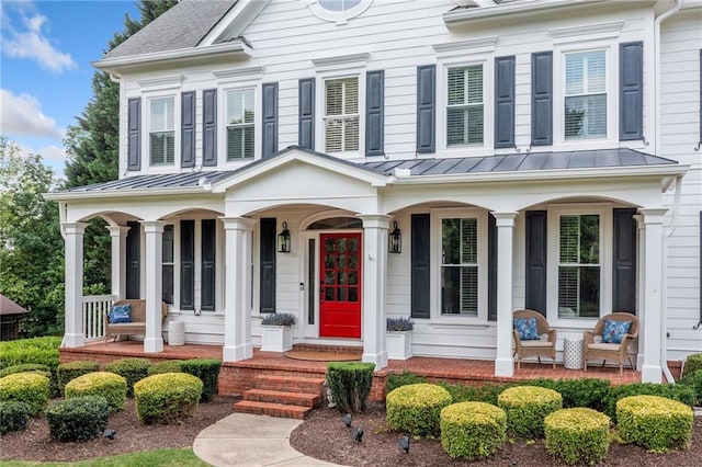 6219 Creekstone Path, Cumming, GA 30041 - greek revival inspired property with covered porch, a standing seam roof, and metal roof