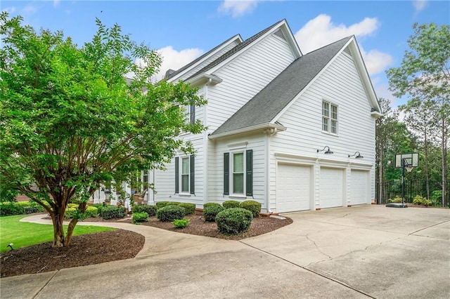 6219 Creekstone Path, Cumming, GA 30041 - view of side of home with a garage, concrete driveway, and a shingled roof