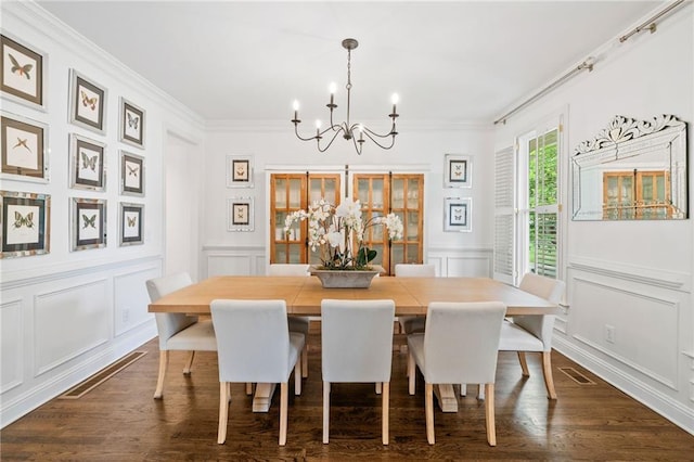 6219 Creekstone Path, Cumming, GA 30041 - dining area with a chandelier, a decorative wall, crown molding, dark wood finished floors, and a wainscoted wall