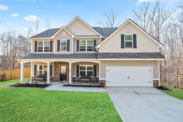 craftsman house featuring board and batten siding, a porch, a front lawn, and fence