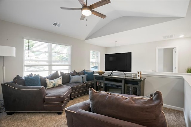 living area featuring visible vents, carpet flooring, lofted ceiling, and a ceiling fan