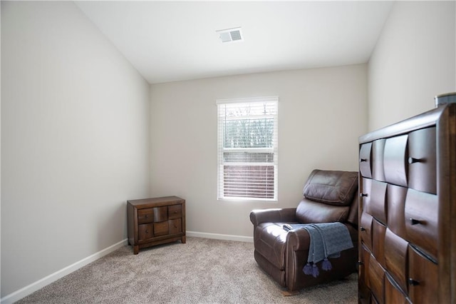 living area featuring light colored carpet, visible vents, and baseboards