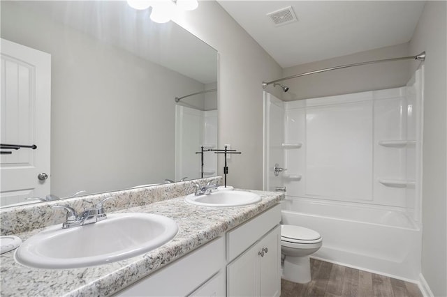 full bathroom with toilet, wood finished floors, visible vents, and a sink