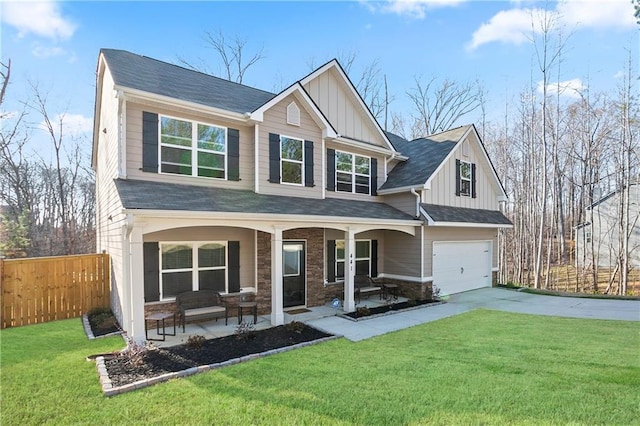 craftsman-style house featuring fence, board and batten siding, covered porch, concrete driveway, and a front yard