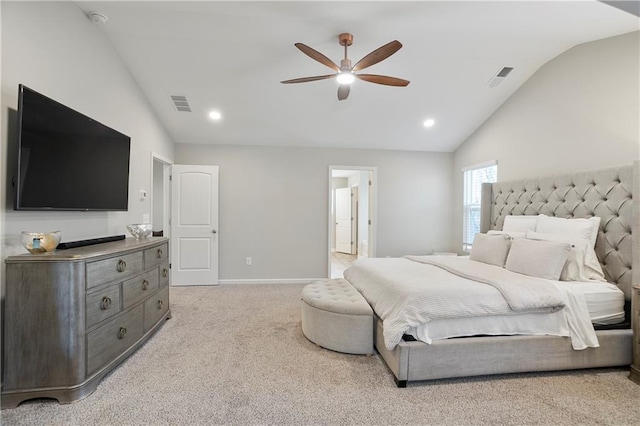 bedroom featuring visible vents, light colored carpet, baseboards, and vaulted ceiling