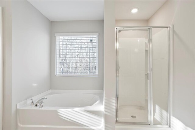 bathroom with a garden tub and a shower stall