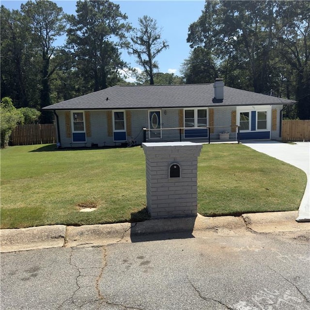 ranch-style home with a front lawn