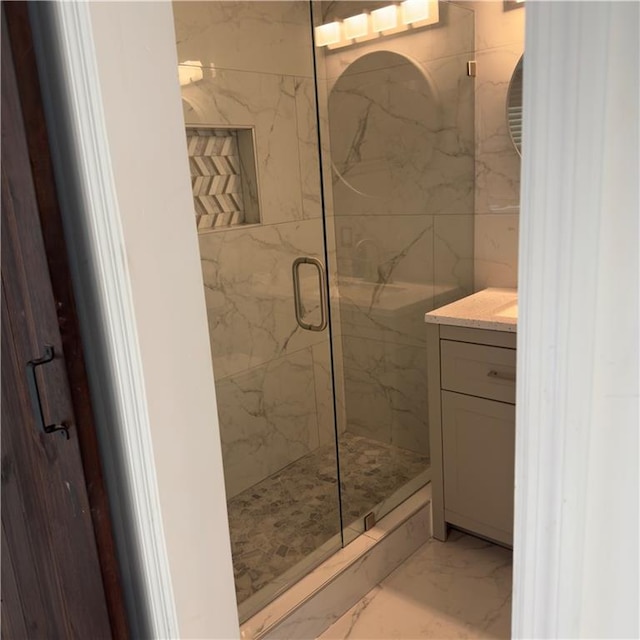 bathroom featuring walk in shower, vanity, and tile walls