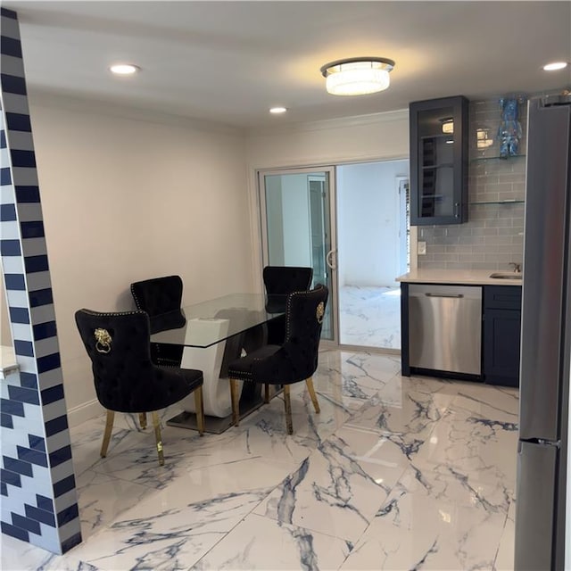 dining space featuring sink and ornamental molding