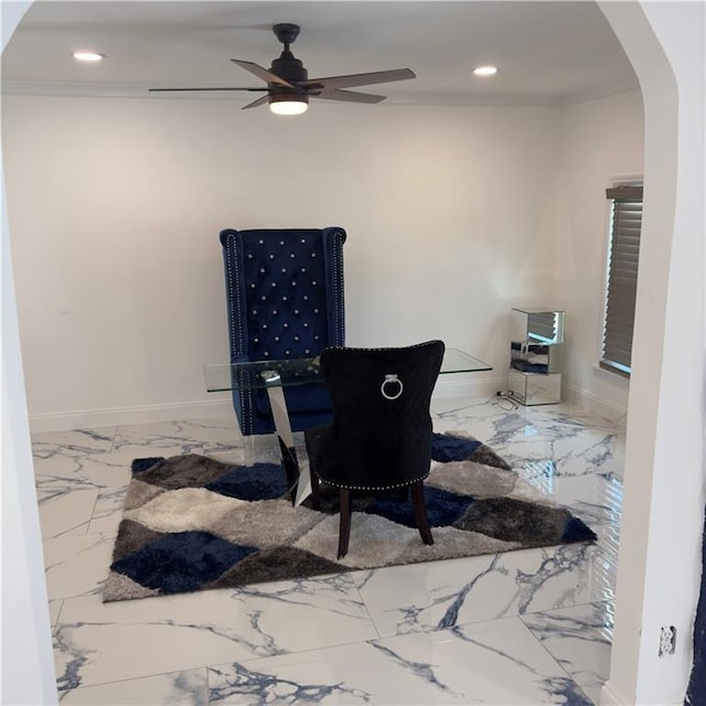 living area featuring crown molding and ceiling fan