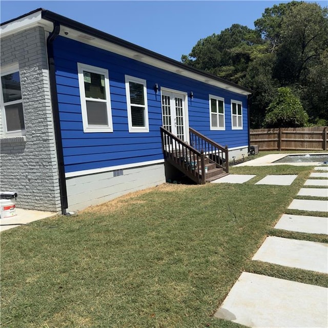 view of front of home with a front lawn and a patio area