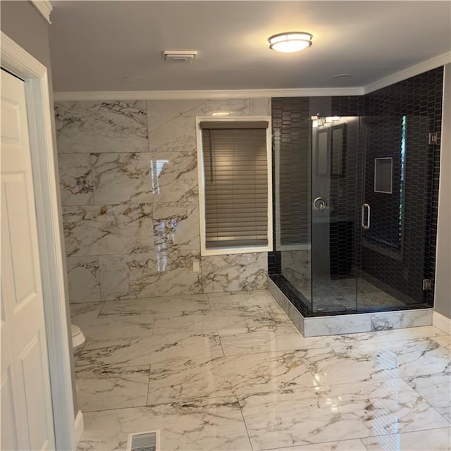 bathroom featuring ornamental molding and a shower with shower door