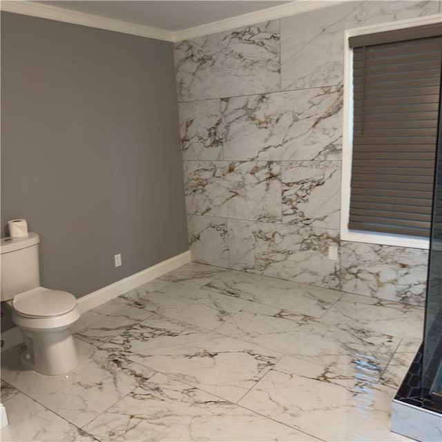 bathroom featuring crown molding and toilet