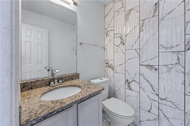 bathroom featuring toilet and vanity