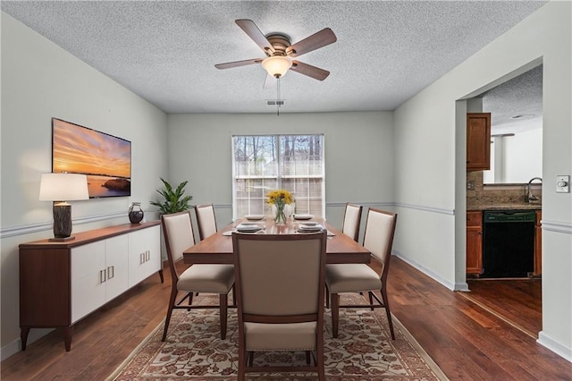 dining space with visible vents, baseboards, a textured ceiling, and dark wood-style flooring