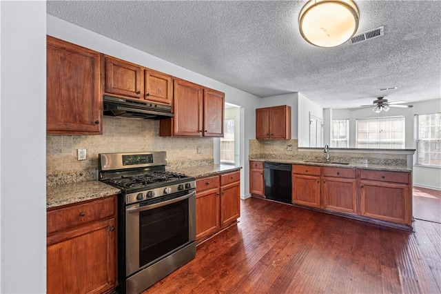 kitchen with visible vents, under cabinet range hood, dark wood-style floors, gas range, and dishwasher