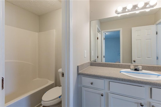 full bathroom with toilet, vanity, tub / shower combination, and a textured ceiling