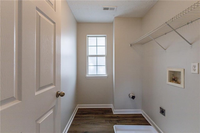 clothes washing area featuring dark hardwood / wood-style flooring, hookup for a washing machine, and hookup for an electric dryer