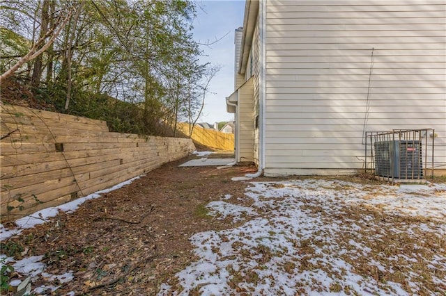 snow covered property featuring central AC