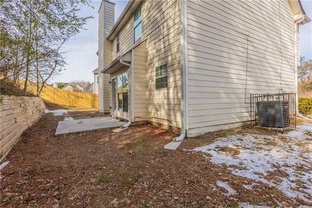 view of side of property with central air condition unit and a patio