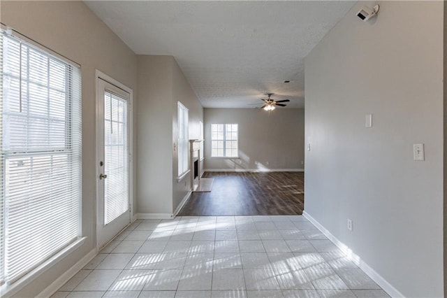 tiled spare room with ceiling fan