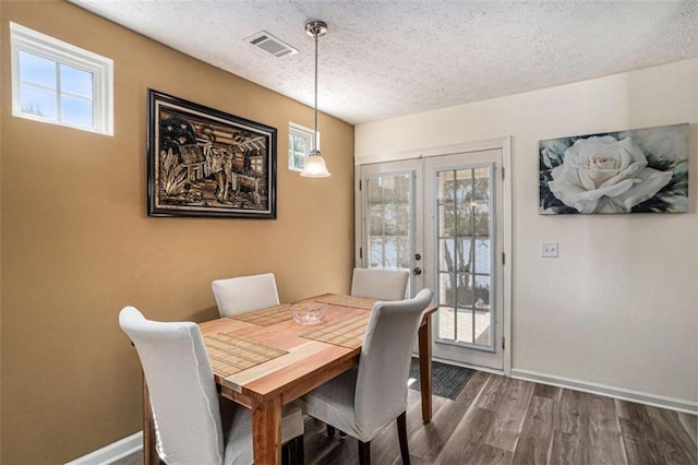 855 Lakeside Cir, Covington, GA 30016 - dining space with a textured ceiling, baseboards, and wood finished floors