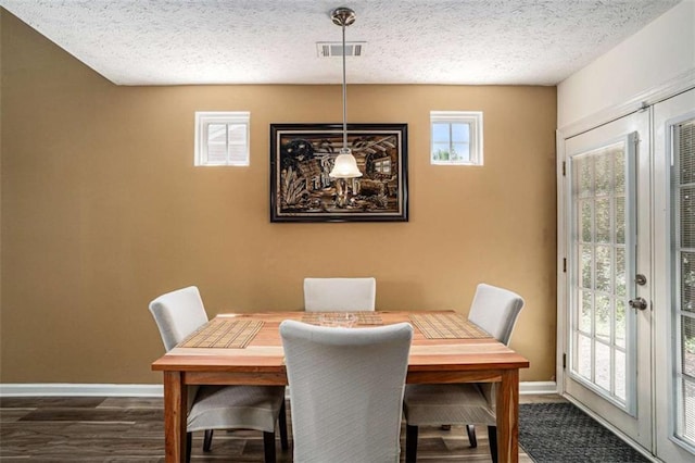 855 Lakeside Cir, Covington, GA 30016 - dining area with dark wood finished floors, baseboards, and a textured ceiling