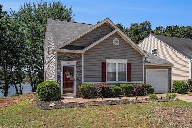 855 Lakeside Cir, Covington, GA 30016 - view of front of home with a garage, stone siding, concrete driveway, and a front yard