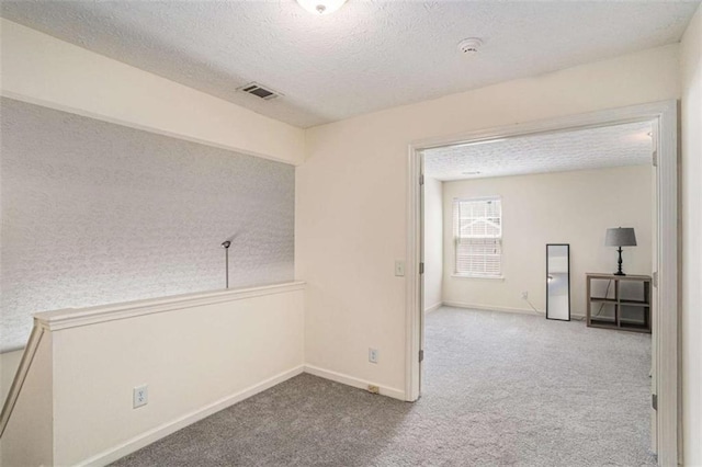 855 Lakeside Cir, Covington, GA 30016 - spare room with carpet floors, a textured ceiling, baseboards, and a smoke detector