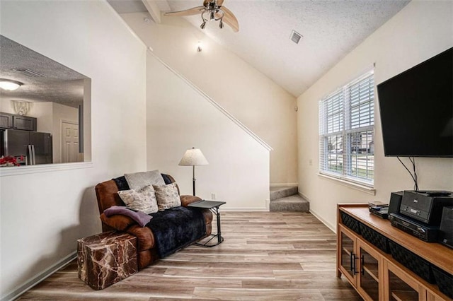 855 Lakeside Cir, Covington, GA 30016 - sitting room featuring lofted ceiling, a textured ceiling, a ceiling fan, light wood-style floors, and baseboards