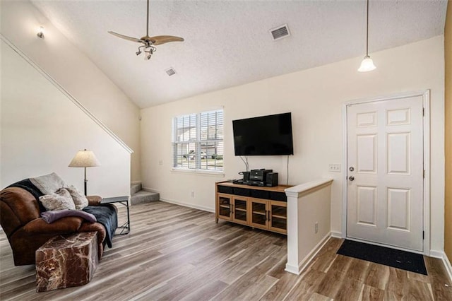 855 Lakeside Cir, Covington, GA 30016 - living room with vaulted ceiling, wood finished floors, a ceiling fan, a textured ceiling, and baseboards