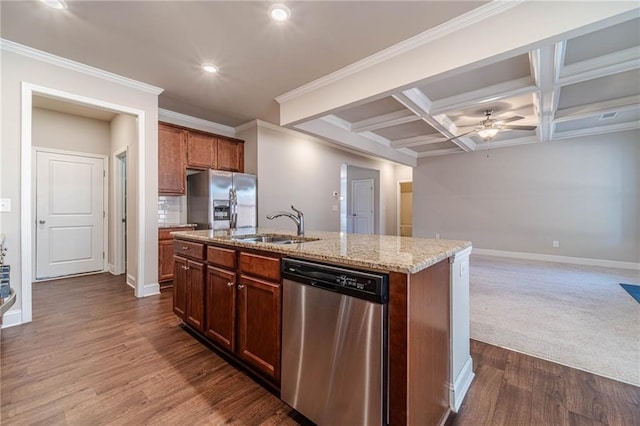 kitchen featuring light stone countertops, coffered ceiling, stainless steel appliances, a ceiling fan, and a sink