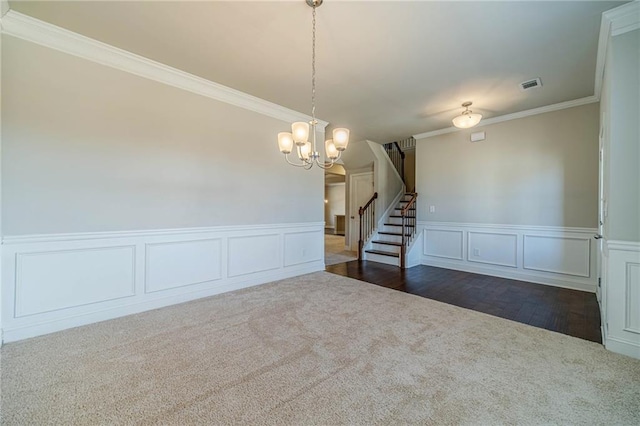 unfurnished room with visible vents, stairs, ornamental molding, an inviting chandelier, and dark colored carpet