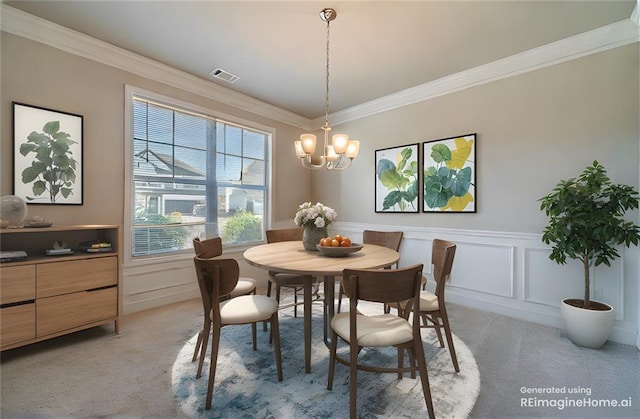 dining area featuring visible vents, an inviting chandelier, ornamental molding, wainscoting, and light carpet