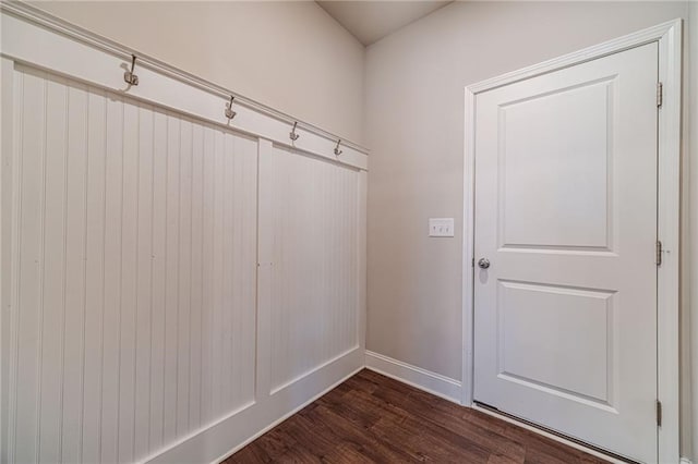 mudroom featuring baseboards and dark wood finished floors