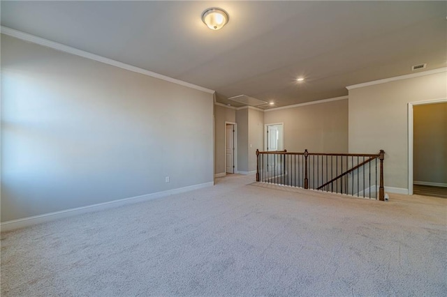 spare room featuring crown molding, attic access, baseboards, and visible vents