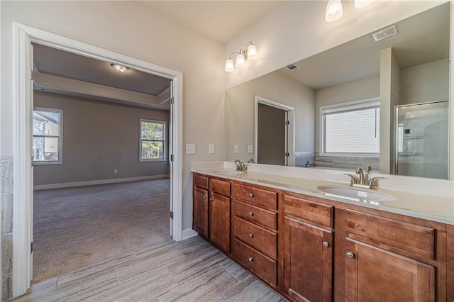 bathroom with a sink, visible vents, and double vanity