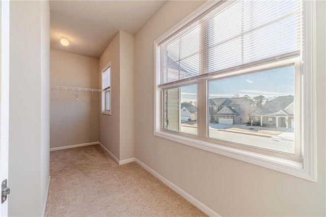 interior space with carpet flooring and baseboards