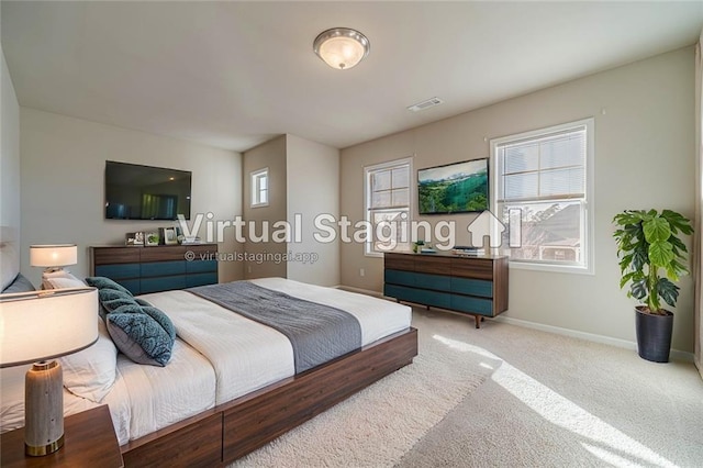 carpeted bedroom featuring visible vents, multiple windows, and baseboards