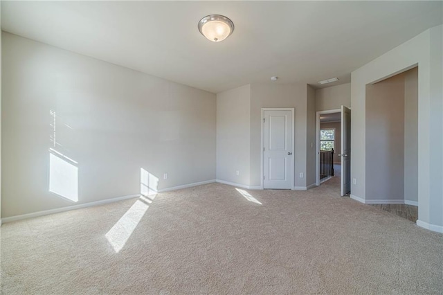 carpeted empty room with baseboards