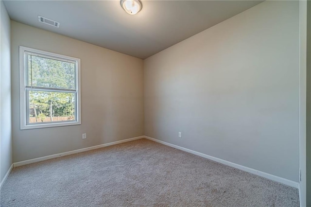 unfurnished room featuring visible vents, baseboards, and carpet flooring