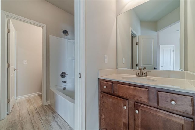 full bath featuring vanity, shower / bath combination, and baseboards