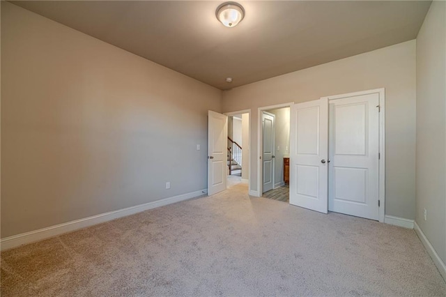 unfurnished bedroom with baseboards and carpet floors