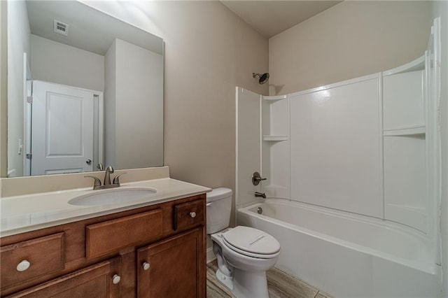 full bath with visible vents, toilet, vanity, and washtub / shower combination