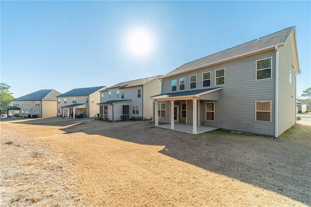 rear view of property with a patio area and a residential view