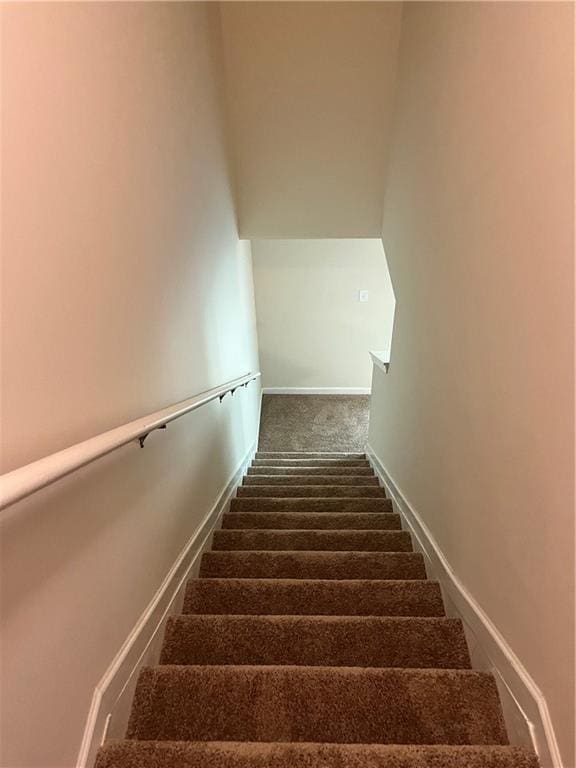 stairway with carpet and baseboards