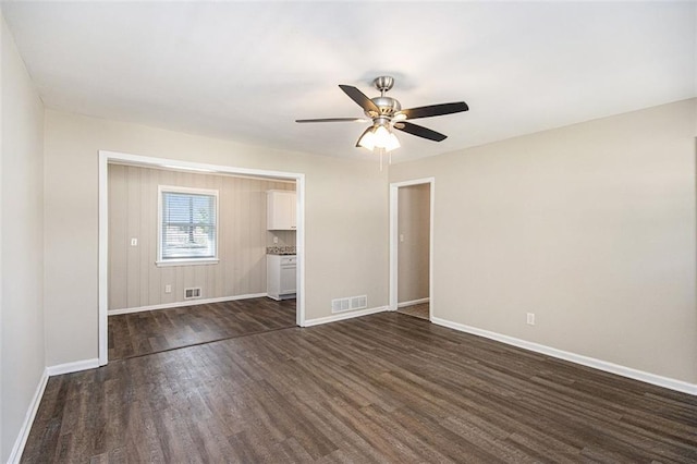 unfurnished bedroom featuring dark wood finished floors, visible vents, and baseboards