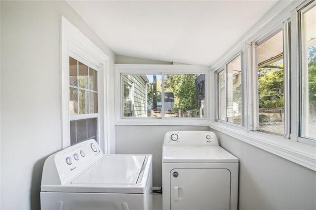 clothes washing area with independent washer and dryer and a wealth of natural light